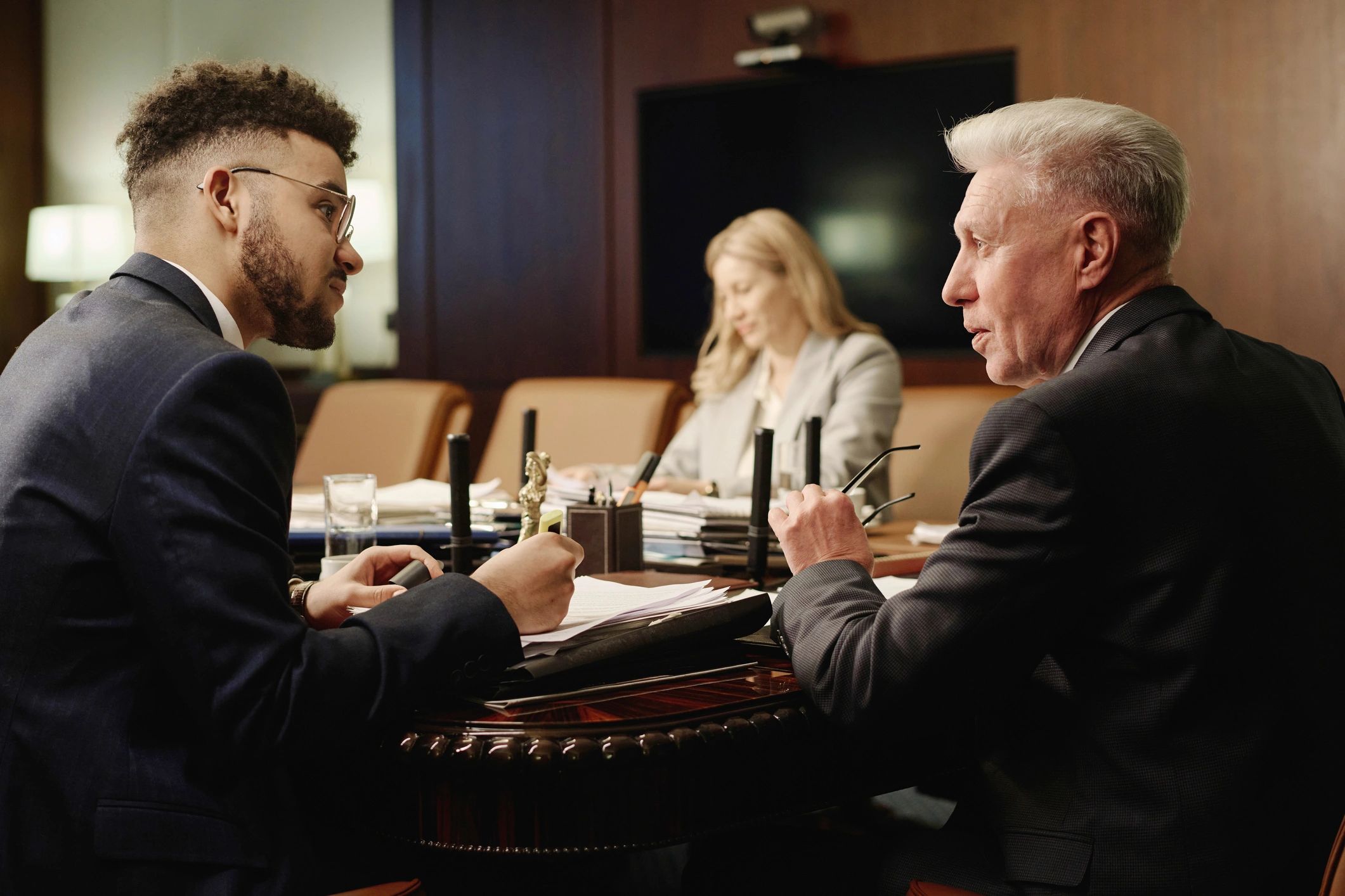 Professionals reviewing documents in conversation